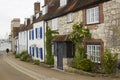 A lone elderly male walks down a street of picturesque terraced houses toward the marina in the village of Warsash.