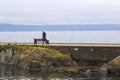 A lone elderly man walks the ancient Long Hole Harbour