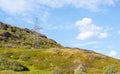 A lone electric iron pole on a hill