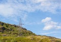 A lone electric iron pole on a hill