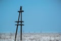 Lone electric pole on the background of a winter landscape