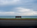 Lone empty bench with sea views