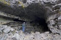 Lone Female Caver At Entrance To Large Cave