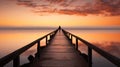 Lone figure standing on a long pier wooden at sunset