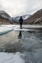 A lone figure walks across a frozen lake Royalty Free Stock Photo