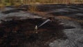 Lone fireman extinguishing the remains of a wildfire in natural reserve Biebrza in Poland