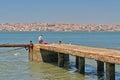 Fisher on a pier along Tagus river