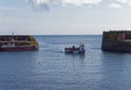 A lone Fisherman bringing in his traditional Fishing Boat into Johnshaven Harbour Royalty Free Stock Photo