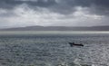 Lone fisherman heading out to sea Royalty Free Stock Photo