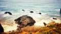 Lone Fisherman on Ocean Boulder