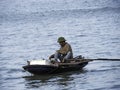 Fisherman pedalling with his foot while fishing. Royalty Free Stock Photo