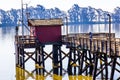 Lone Fisherman On Pier At Rivers Shoreline