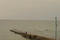 A lone fisherman sitting on the pier Royalty Free Stock Photo