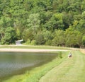 Lone fisherman waiting for a fish to bite on a lazy summer day Royalty Free Stock Photo