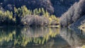 A lone fisherman tries to catch a fish using his fishing rod, Lago Santo Modenese, Italy Royalty Free Stock Photo