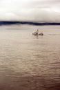 Lone Fishing Boat Motors Out Strait Heading to Sea Royalty Free Stock Photo