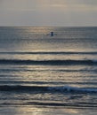 Lone Fishing Boat Out to Sea at Sunset at Kuta Beach