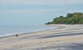 Lone girl sits on a beach for some alone time, but takes her cell phone with her.