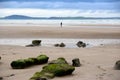 Lone girl walking near unusual mud banks Royalty Free Stock Photo