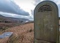 A lone grave stone sits up top in the Peak District Forest, UK Royalty Free Stock Photo