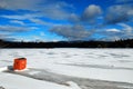 A lone ice fishing shack stands on a frozen lake Royalty Free Stock Photo