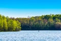 A lone kayaker paddles across the waters of Worster Lake at Potato Creek State Park in North Liberty, Indiana