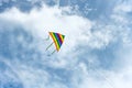 A lone kite soars in the sky near many clouds Royalty Free Stock Photo