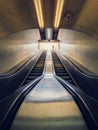 Lone man climbing out on a subway escalator. Symmetrical underground moving staircase