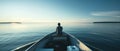 A Lone Man Confidently Steering A Boat On Calm Waters