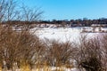 Lone man drilling for ice fishing on frozen lake