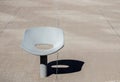 Lone metallic chair sunk in concrete yard Royalty Free Stock Photo
