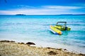 Lone motorboat with banana boat on the sea water