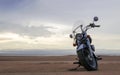 Off-road motorcycle standing still in the open desert beneath heavy clouds Royalty Free Stock Photo