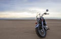 Off-road motorcycle standing still in the open desert beneath heavy clouds Royalty Free Stock Photo