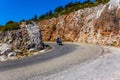 A lone motorcyclist on a mountain road