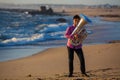 Lone musician play to Tuba on romantic sea shore. Royalty Free Stock Photo