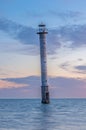 A lone old lighthouse standing in the see