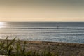 Lone paddle boarder on a calm sea in the afternoon Royalty Free Stock Photo