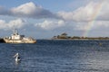 A lone pelican swims in the bay with an old ship and rainbow in the sky in the background, Kangaroo Island, Southern Australia Royalty Free Stock Photo