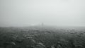 Lone person is shown standing alone on a misty day