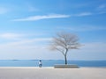 a lone person standing in front of a tree