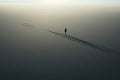 Lone person standing in the middle of vast expanse of water. Generative AI