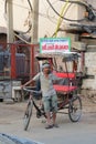 Lone rickshaw wallah waiting for customers in old Delhi India. Royalty Free Stock Photo