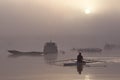 Lone rower on river at misty sunrise Royalty Free Stock Photo