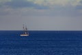 Lone Sail Ship on a blue, clear horizon, calm ocean Royalty Free Stock Photo