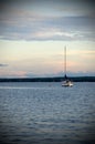 Lone Sailboat with Evening Light On the River