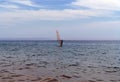 a lone sailboat, sliding on the smooth surface of the black sea in Arkhipo-Osipovka. Royalty Free Stock Photo