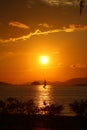A lone sailboat at sunset. Royalty Free Stock Photo
