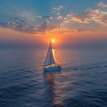 A lone sailboat on a vast ocean at sunset Royalty Free Stock Photo