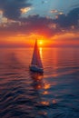 A lone sailboat on a vast ocean at sunset Royalty Free Stock Photo